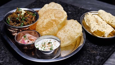 Goat Curry with Fried Bread, Cucumber Raita and Pickled Onions