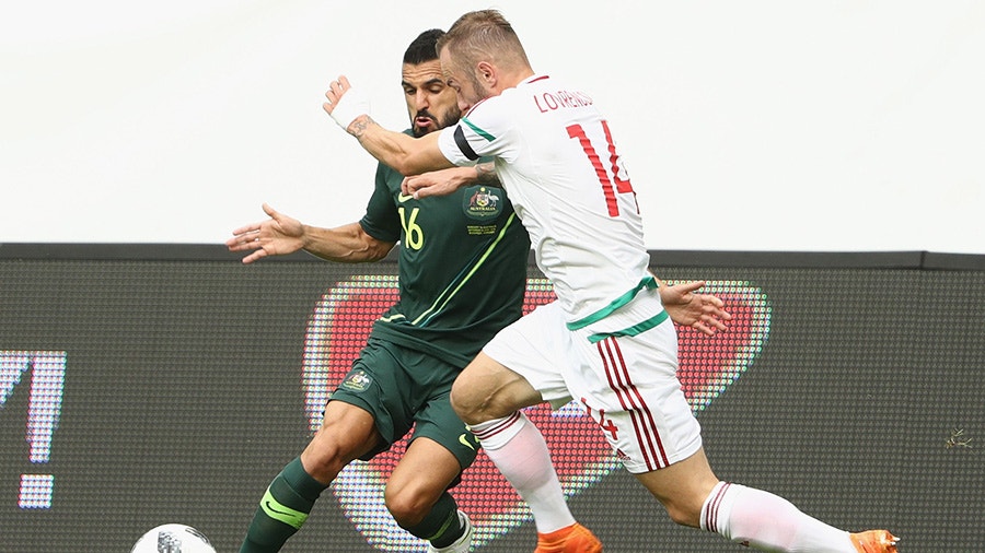 Aziz Behich of Australia is challenged by Gergo Lovrencsics of Hungary.