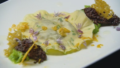 Egg Yolk and Black Pudding Ravioli with Pea Puree and Parmesan Crisp