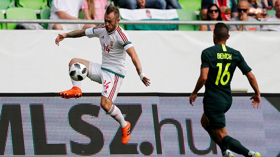 Gergo Lovrencsics of Hungary controls the ball next to Aziz Behich of Australia.