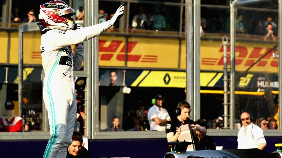 Pole position qualifier Lewis Hamilton of Great Britain and Mercedes GP celebrates in parc ferme during qualifying for the F1 Grand Prix of Australia