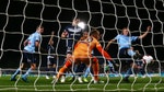 Victory goalkeeper Lawrence Thomas fails to stop a goal by Aaron Calver of Sydney FC as Rhyan Grant of Sydney FC plays for the ball