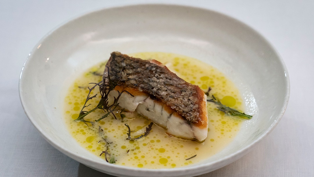 Crispy Skin Barramundi with Wilted Fennel, Fish Head and a Sake Reduced Broth