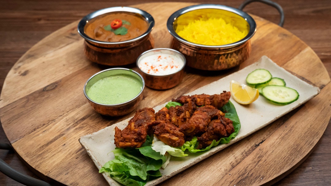 Lamb Mughlai Curry with Saffron Rice and Raita and Indian Chicken Kebab with Coriander and Mint Chutney