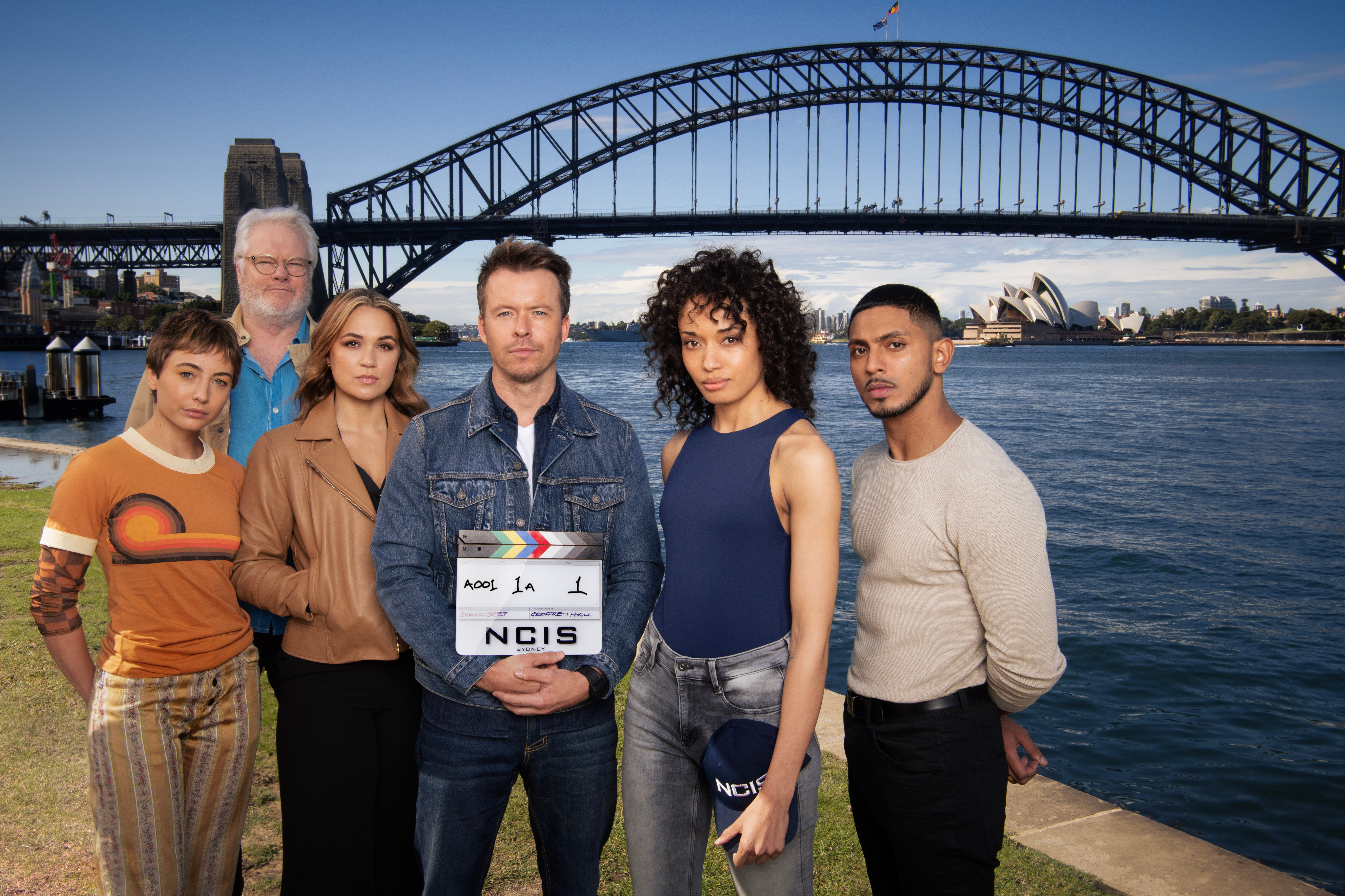The NCIS:Sydney cast from left to right: Mavournee Hazel as Forensic Pathologist “Bluebird 'Blue' Gleeson, William McInnes as Forensic Pathologist Dr. Roy Penrose, Tuuli Narkle as AFP Liaison Officer Constable Evie Cooper, Todd Lasance as AFP Liaison Officer Sergeant Jim 'JD' Dempsey, Olivia Swann as NCIS Special Agent Captain Michelle Mackey and Sean Sagar as Special Agent DeShawn Jackson. PHOTO CREDIT: Daniel Asher Smith/Paramount+ © TM & © 2023 CBS Studios Inc. NCIS: Sydney and related marks and logos are trademarks of CBS Studios Inc. All Rights Reserved.